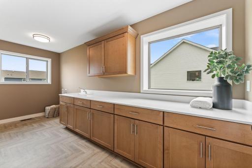 Grand laundry room is a dream, with tons of storage.