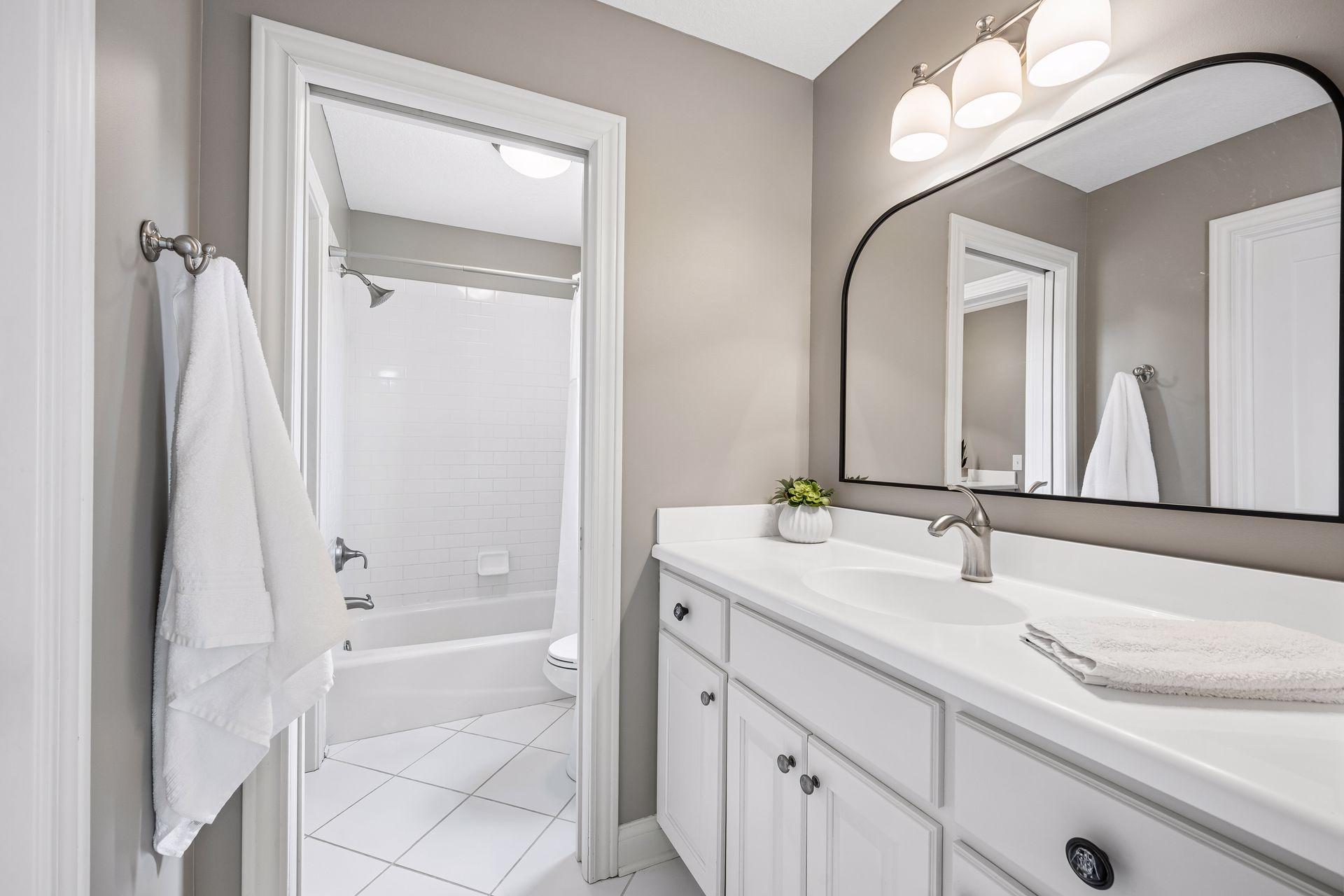 Private vanity area with shared toilet and shower room