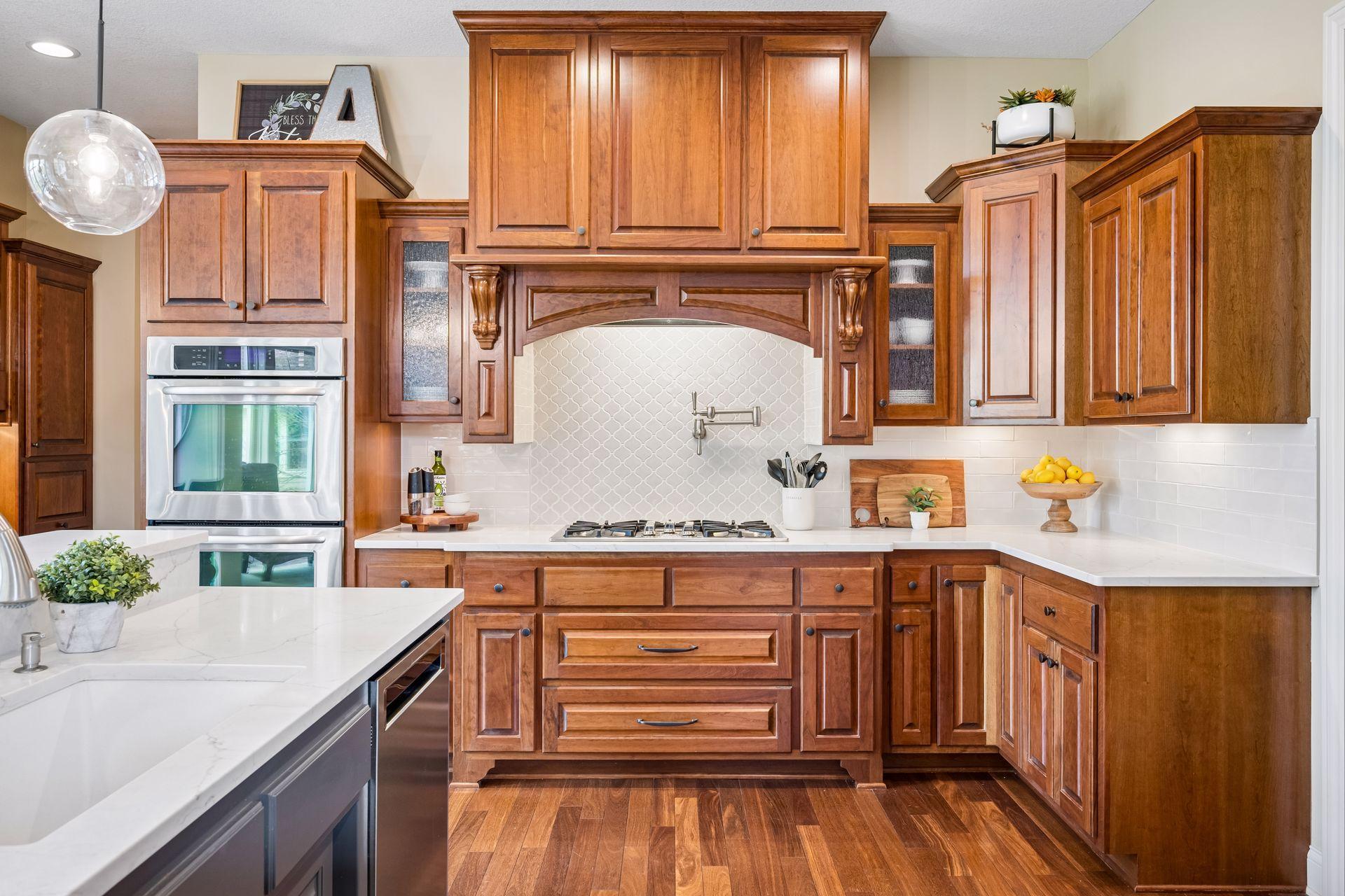 Custom range hood features pull out spice cabinets