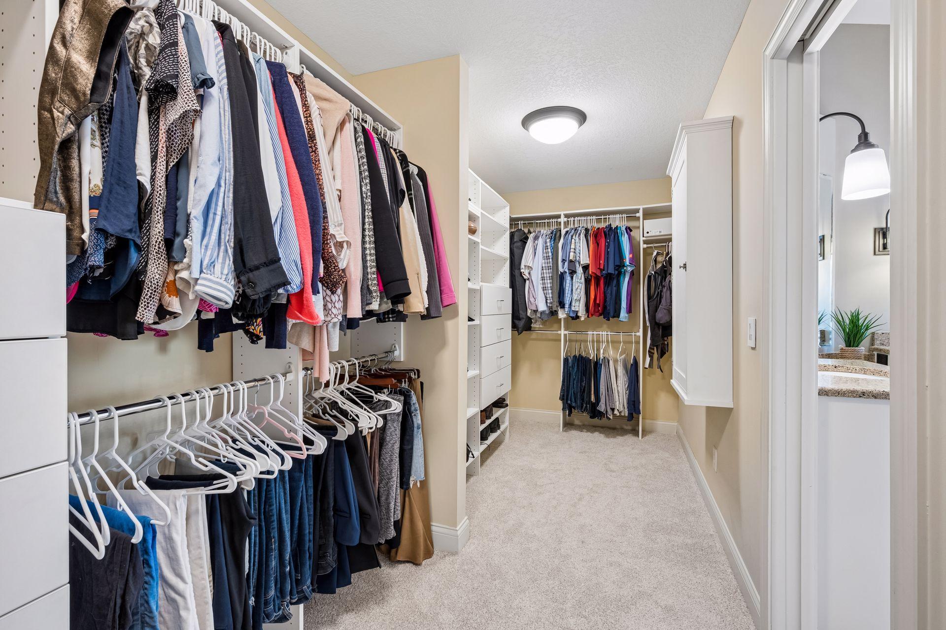 Walk-in closet with custom shelving and built-in ironing board