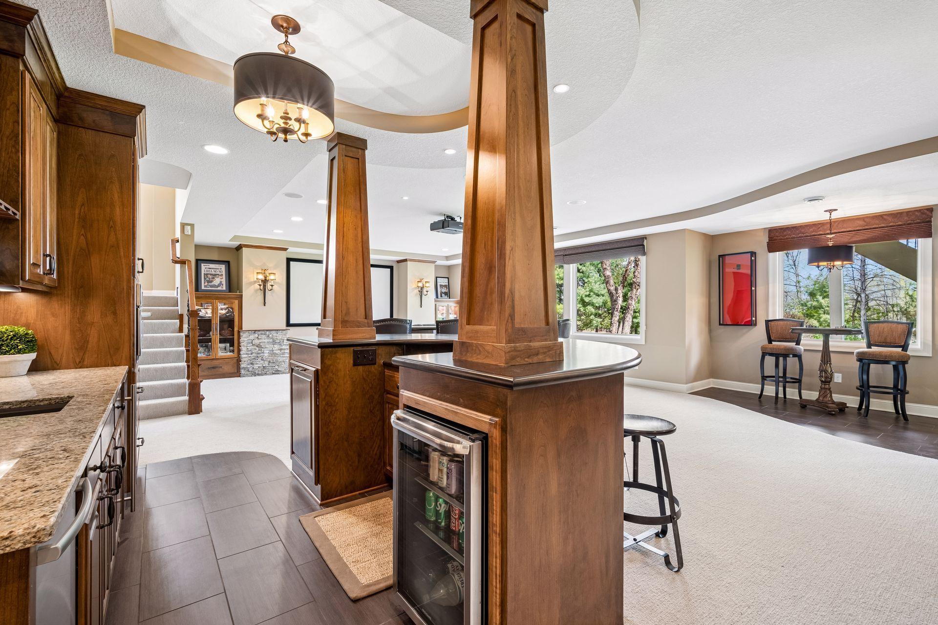 Bar area has a pull-out trash and beverage refrigerator