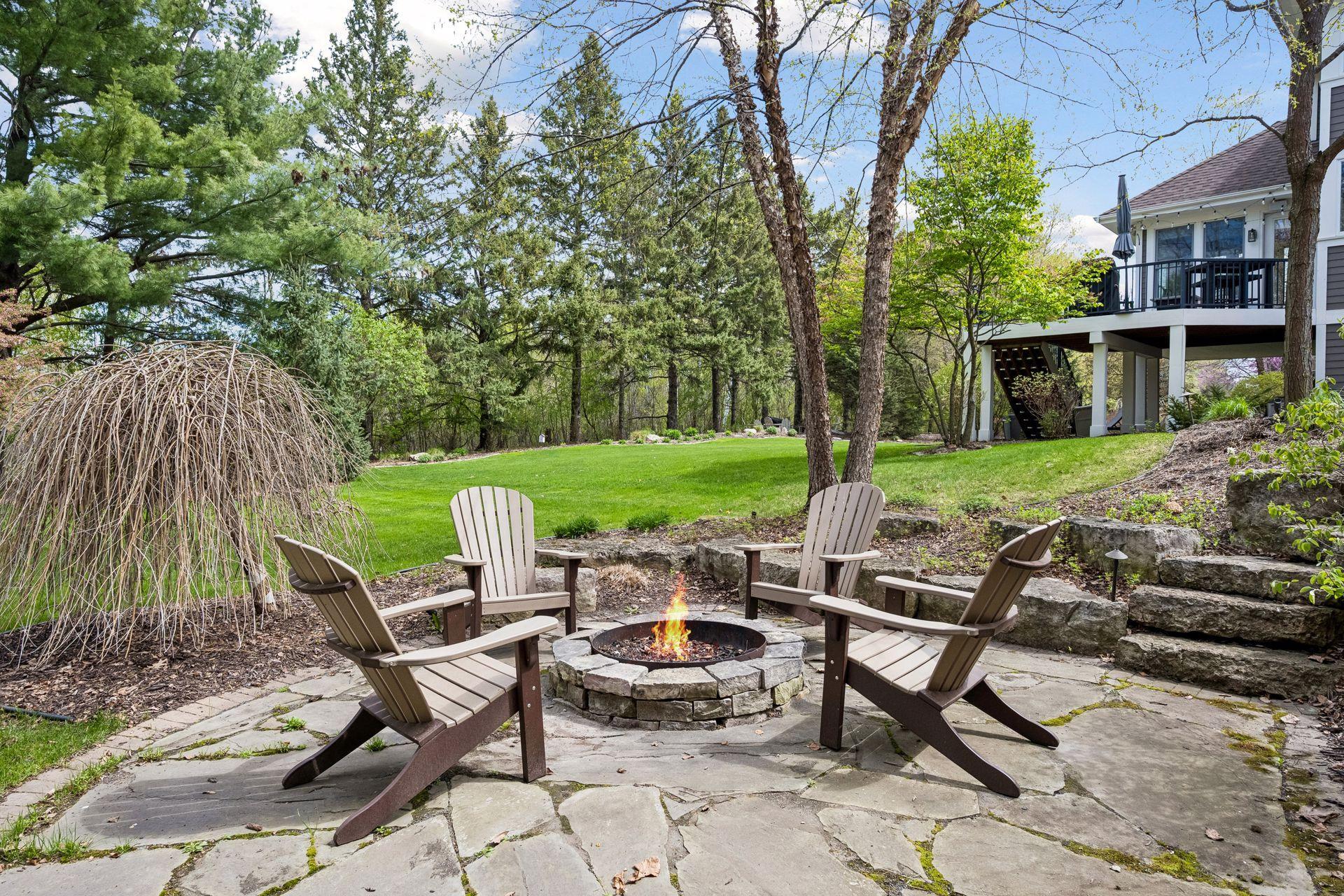 Stone patio features fire pit and stone retaining walls