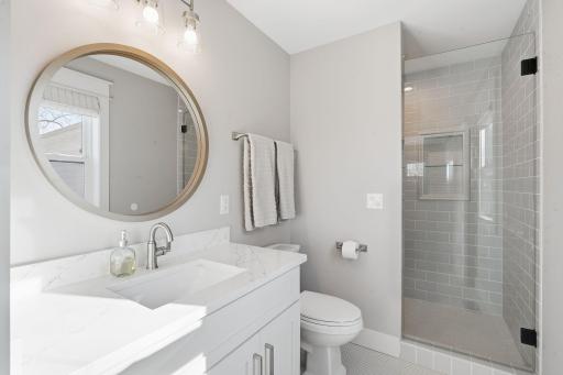 Private bathroom in junior suite, includes walk-in tiled shower.
