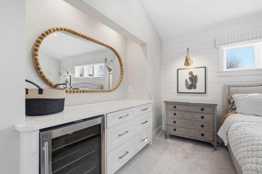 Primary suite equipped with beverage center.