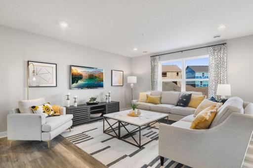 Another view of the wide-open main floor. Perfect for entertaining. Photo is of model home. Colors and options may vary. Ask Sales Agent for details.