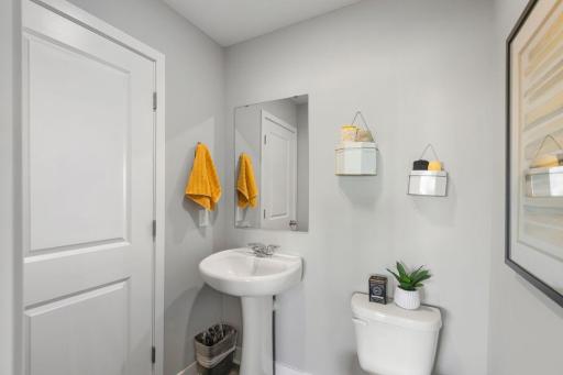 Convenient half bath situated on the main level. Photo is of model home. Colors and options may vary. Ask Sales Agent for details.