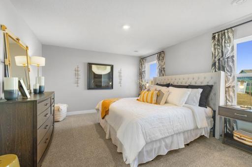 An oasis of its own, the primary suite offers the perfect escape. There's immediate access to a private bathroom that features dual sinks and a large shower. Photo is of model home. Colors and options may vary. Ask Sales Agent for details.
