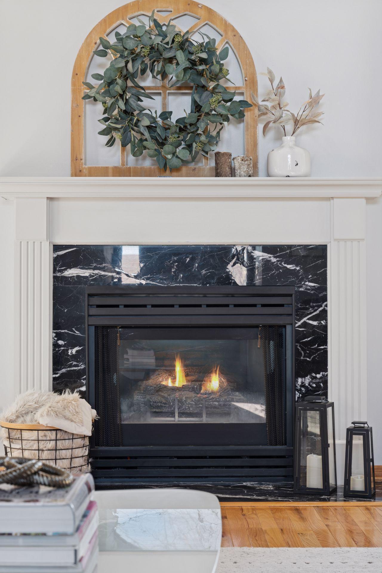 Gas fireplace w/ the newly refinished mantel.