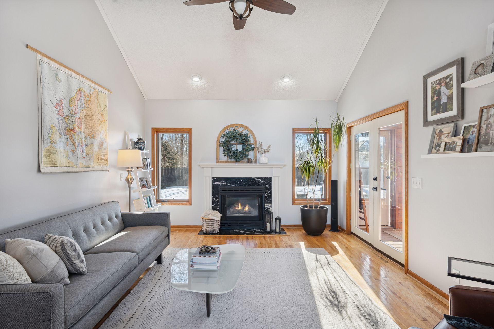 Lots of natural light in the main floor living area that features hardwood floors, gas fireplace and a newly refinished mantel.