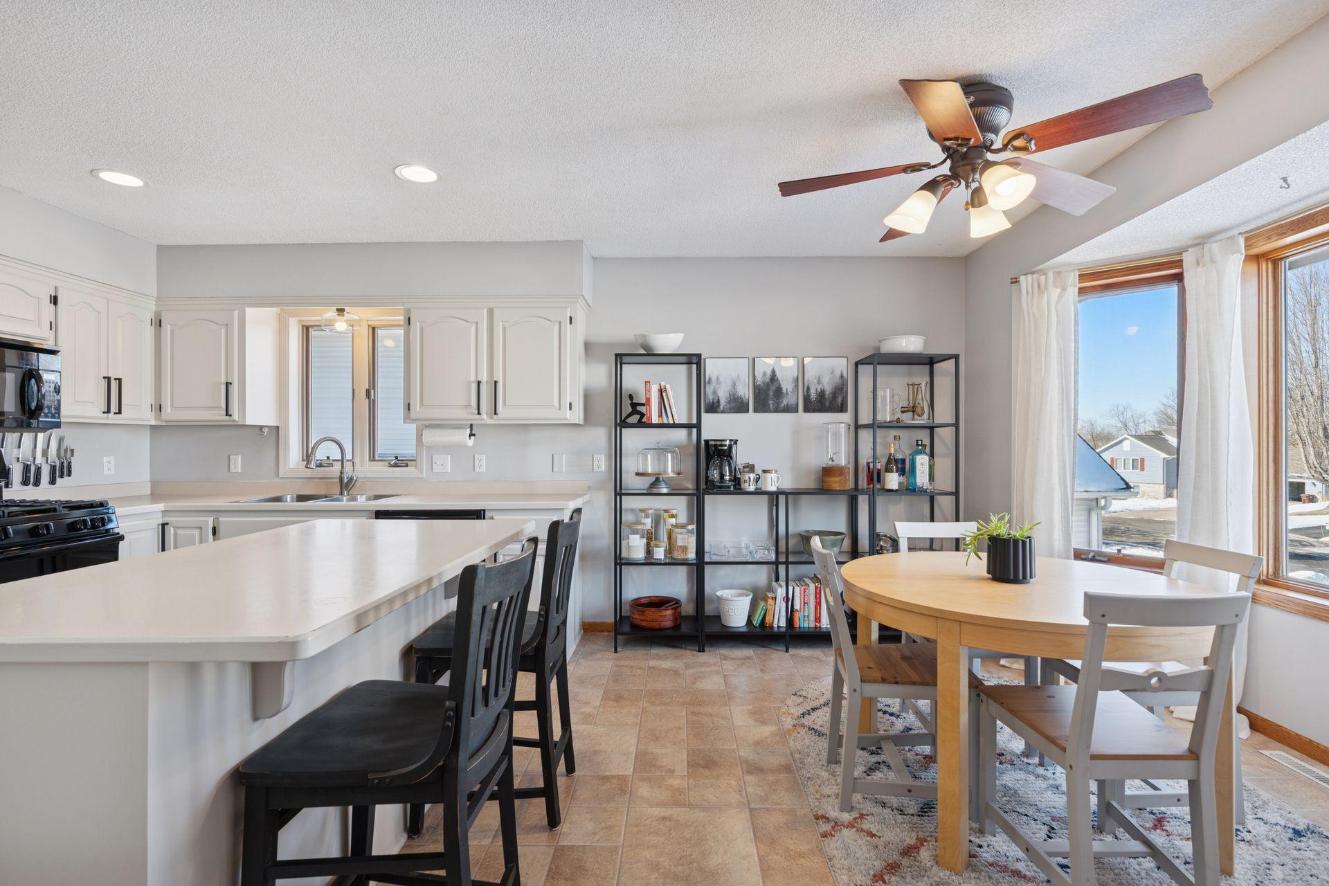 Dining area with bay window and large windows for natural light.
