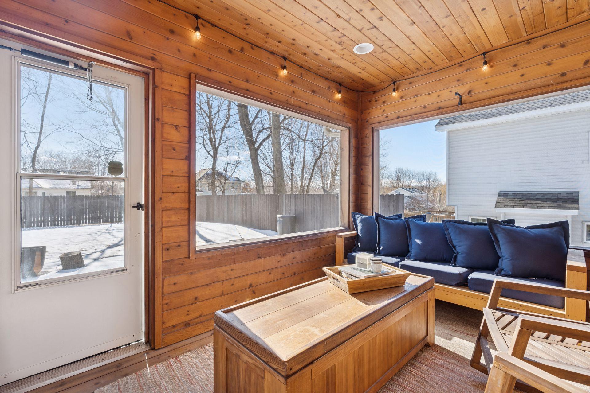 Walks out to a large paver patio and partially fenced backyard.