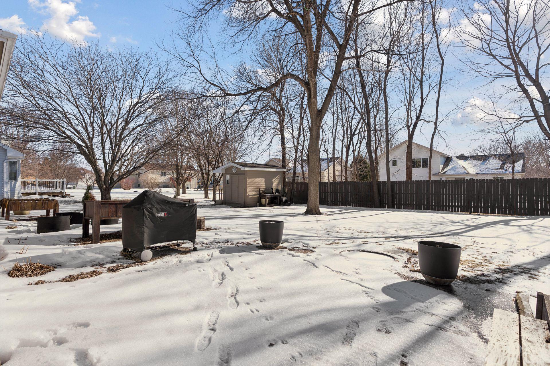 Great view of the flat backyard w/ a shed and newer wood fence for privacy.