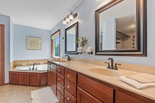 Primary bath features a jetted bathtub, large countertop and a walk in shower