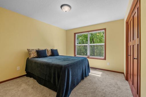 Bedroom located upstairs with view of backyard and the woods