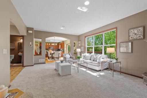 The large windows overlook the backyard. Note the arch into the kitchen