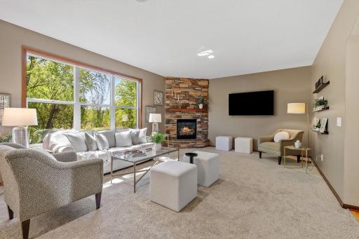 The spacious living room features new carpet and a gas fireplace for nights in.