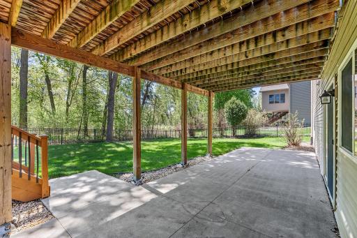 The walk lower level with a patio and stairs going up to the deck