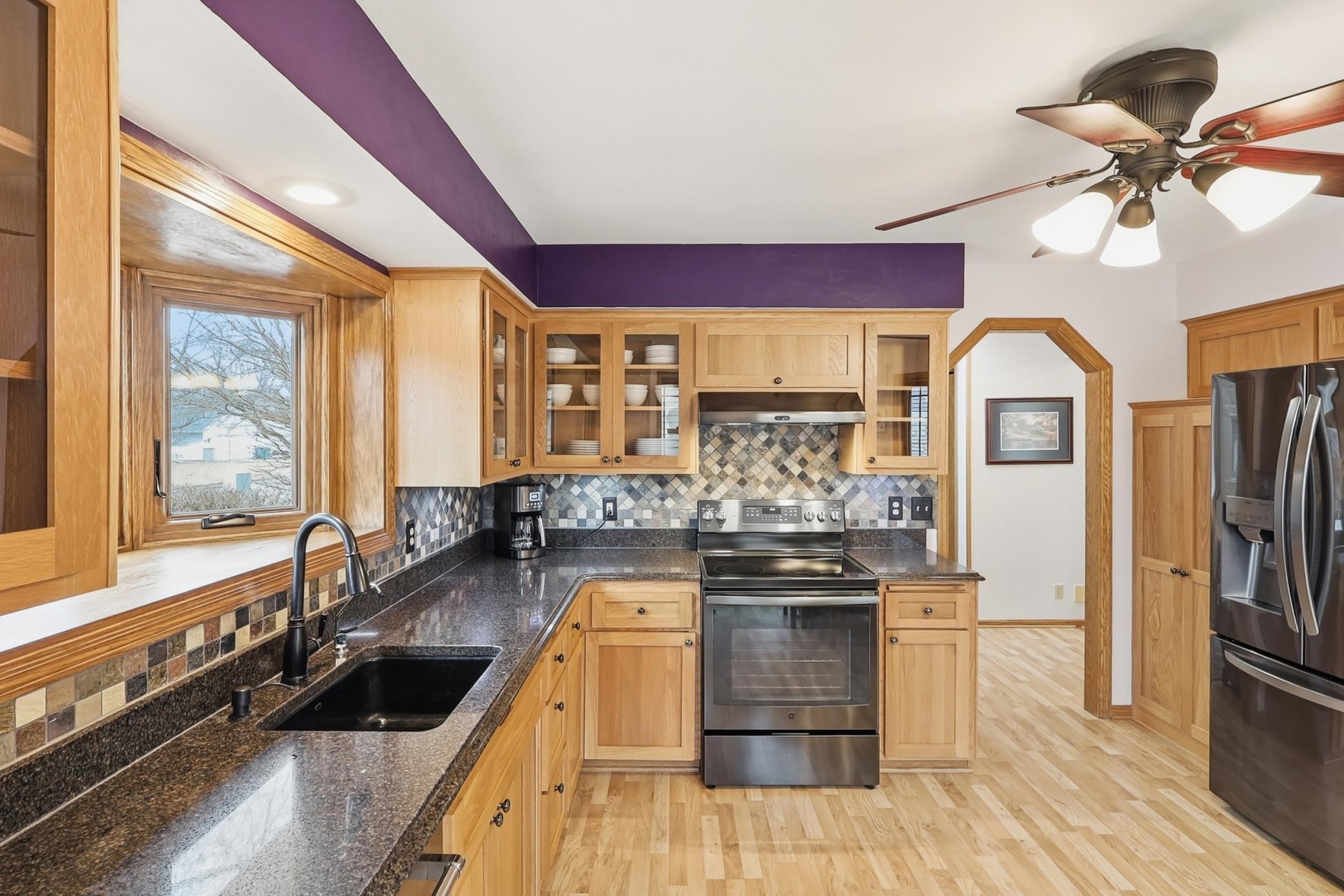 The eat in kitchen has updated wood cabinetry, and plenty of space for cooking and dining.