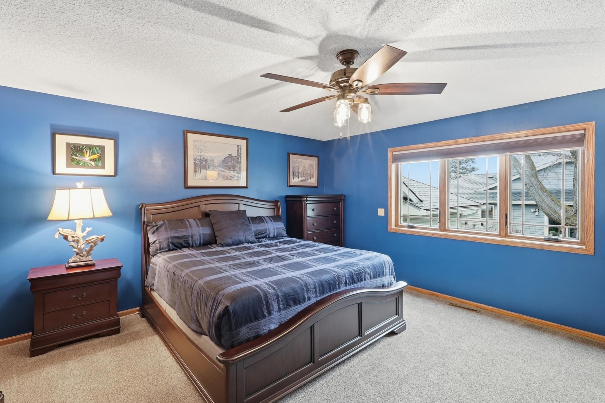 The owner’s suite featuring French doors, a roomy walk-in closet, and a remodeled walkthrough bath with a walk-in shower, jetted tub, double vanities, and a skylight.