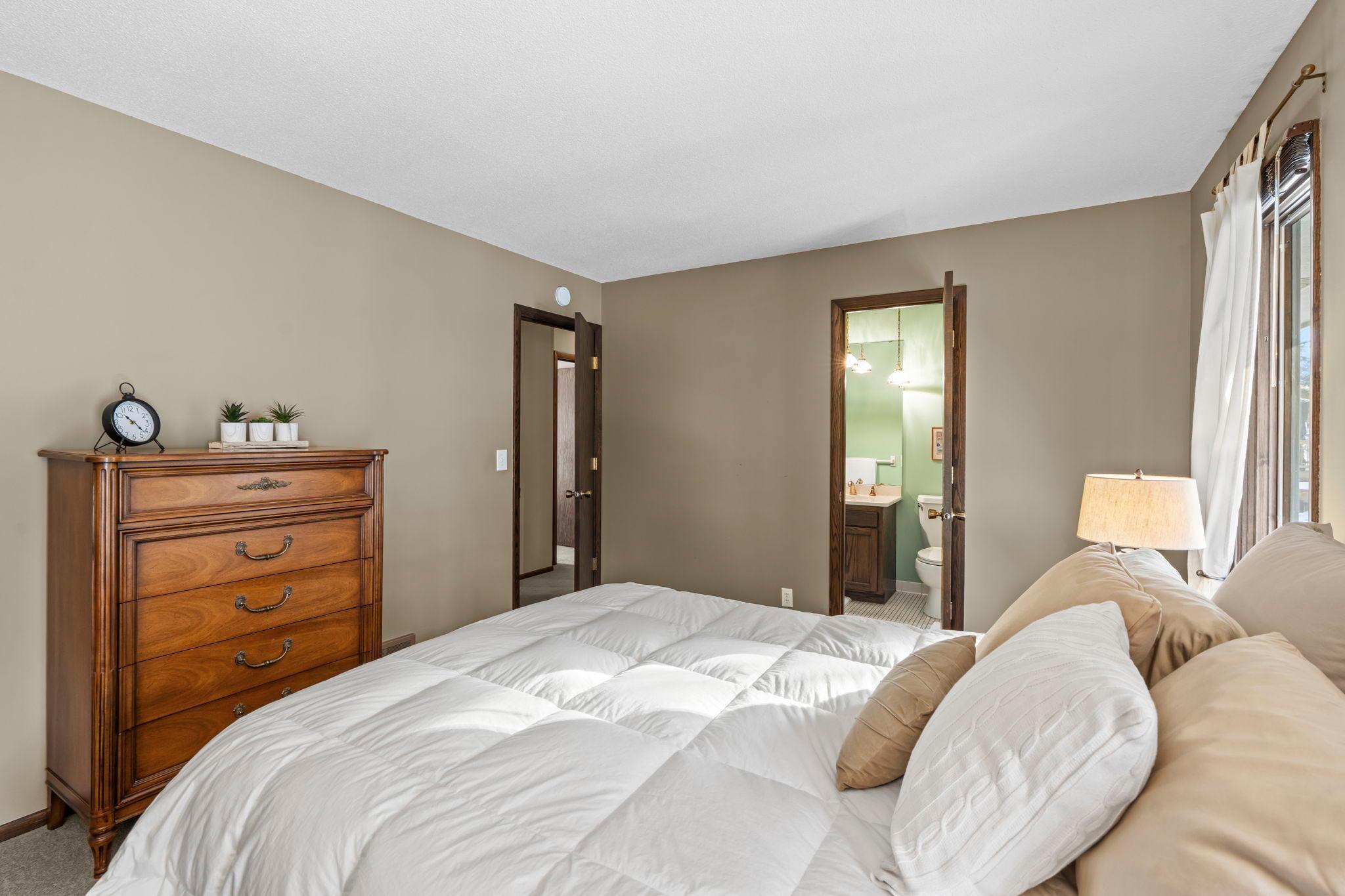 Primary bedroom with walk-through full bathroom and walk-in closet.