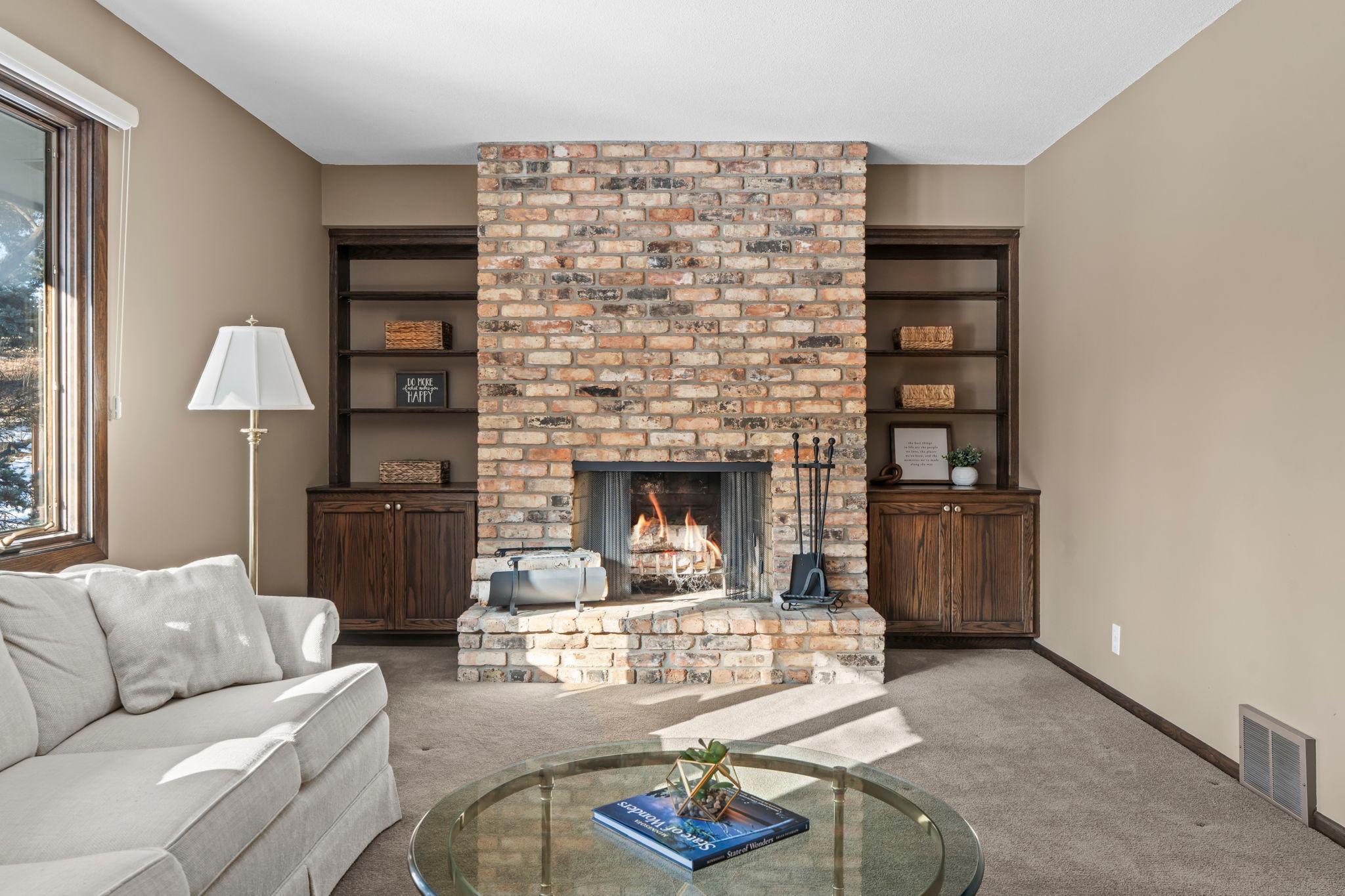 Two brick fireplaces. Main level fireplace features accent shelving which is a highlight on this spacious main level.