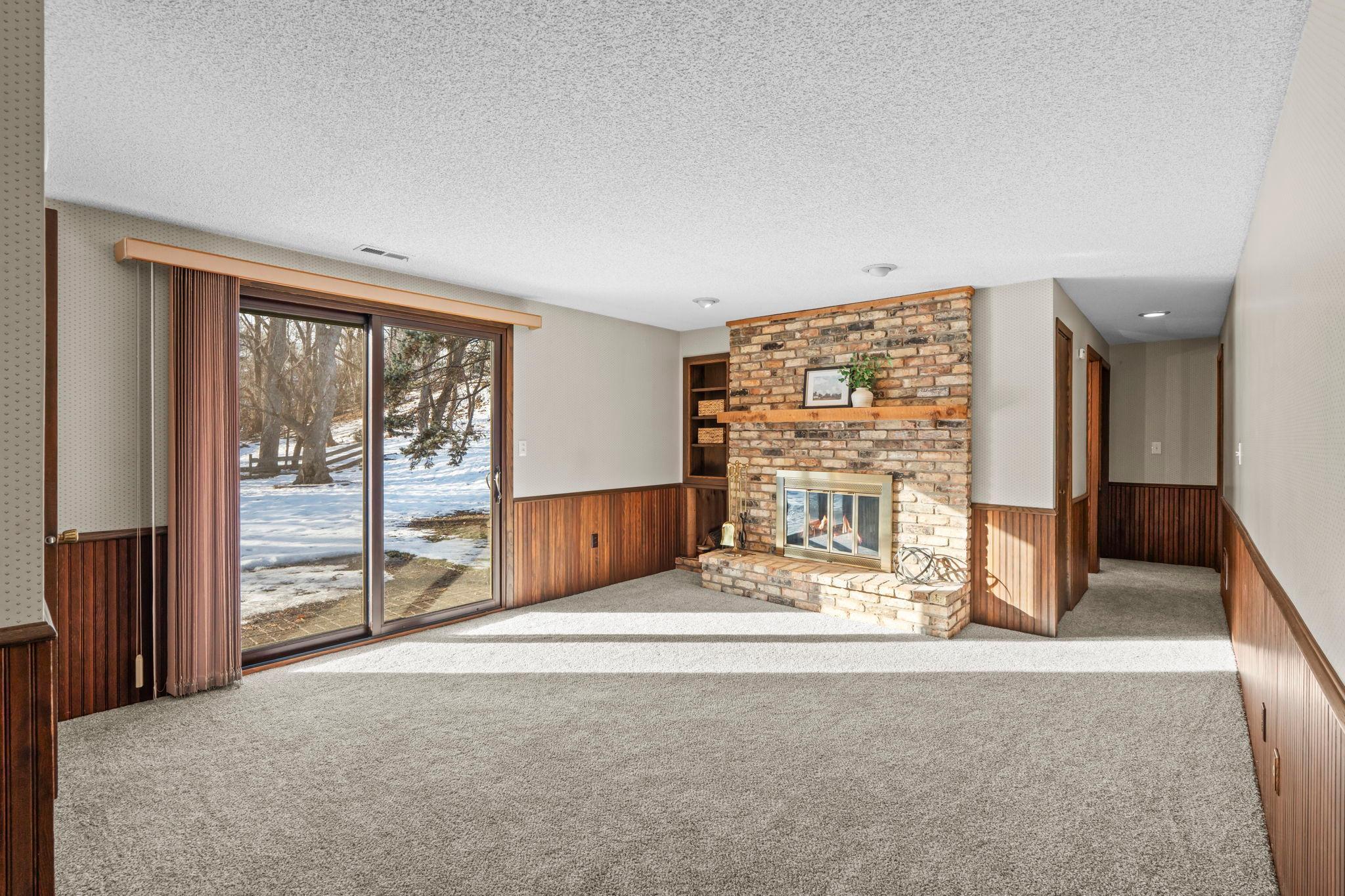 Fantastic walkout lower level retreat with beautiful, brick fireplace.