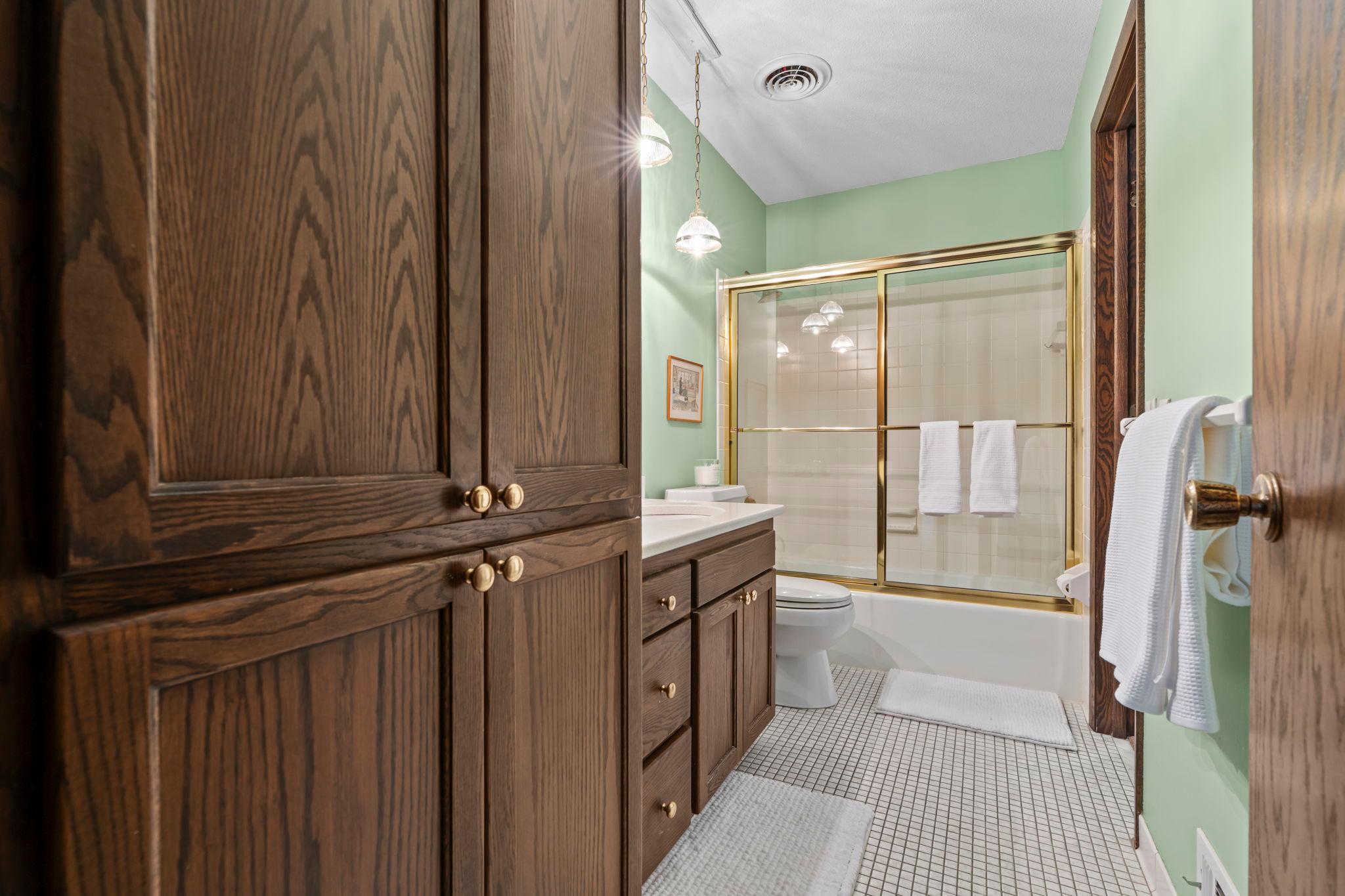 Main level bathroom offers walk-through from Primary. Ceramic tiled floors, Cambria countertops and more!