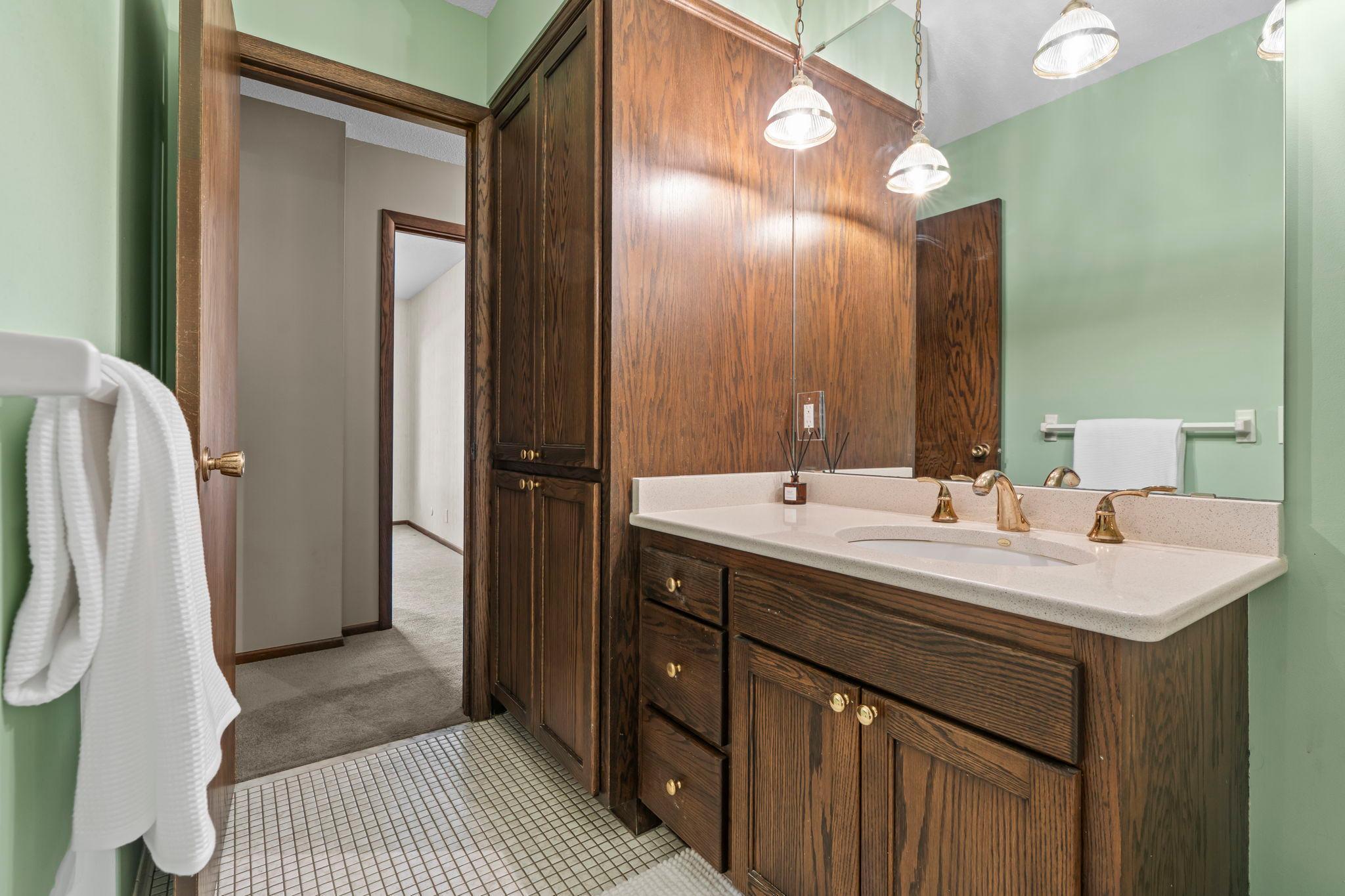 Main level bathroom offers walk-through from Primary. Ceramic tiled floors, Cambria countertops and more!