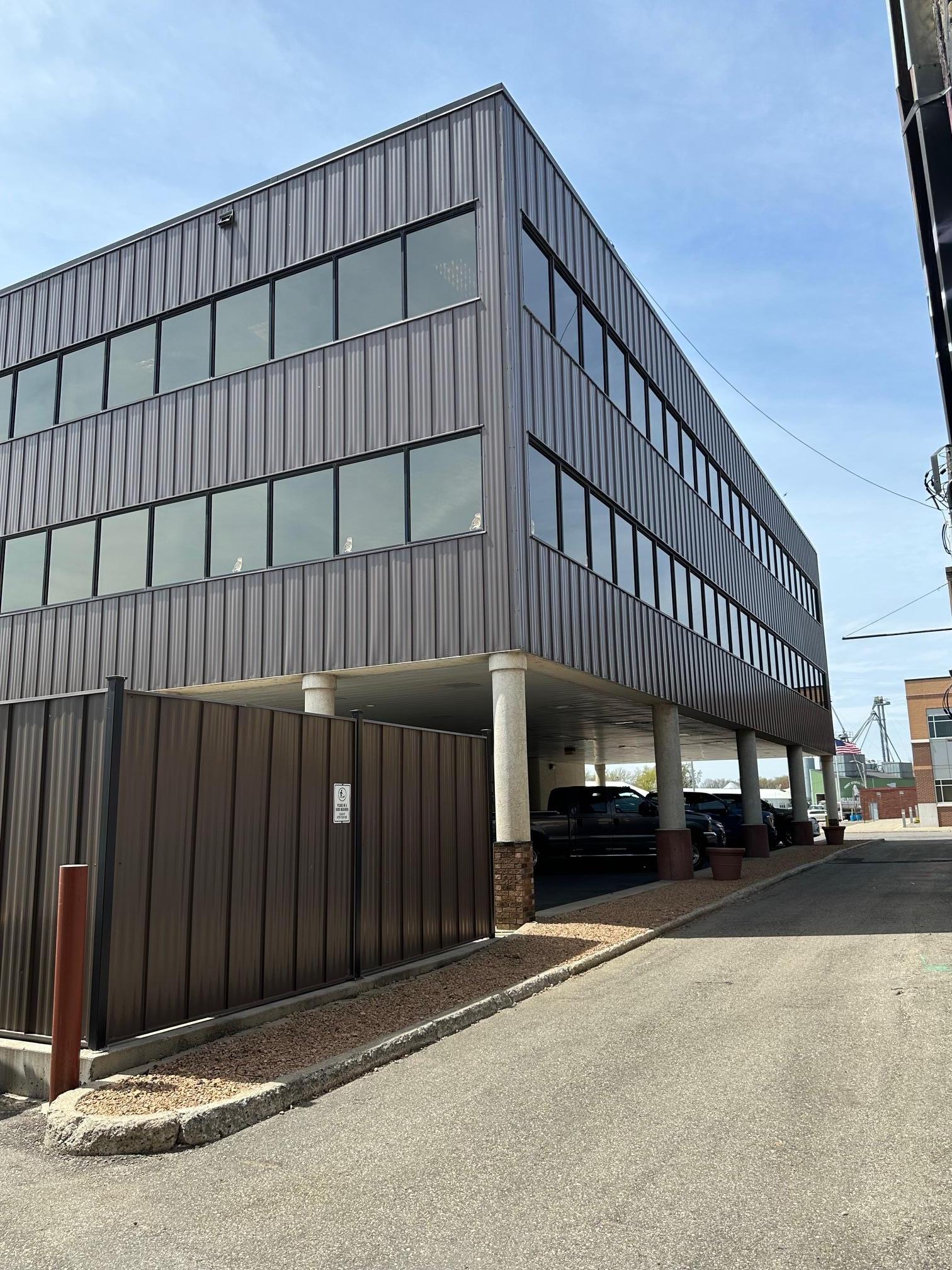 Rear of building with covered parking and generator enclosure