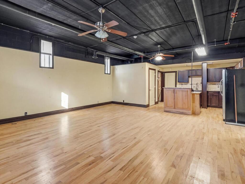 Lower level common area with full kitchen, bathroom, walk in closet and laundry facilities.