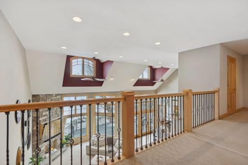 Spacious upper-level landing overlooking the great room with striking architectural details