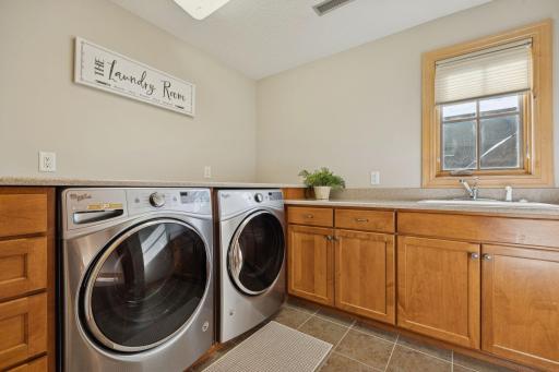 Upper level Laundry with cabinets and sink