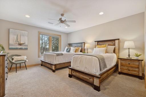 Spacious bedroom with dual beds, soft neutral tones, and peaceful natural light