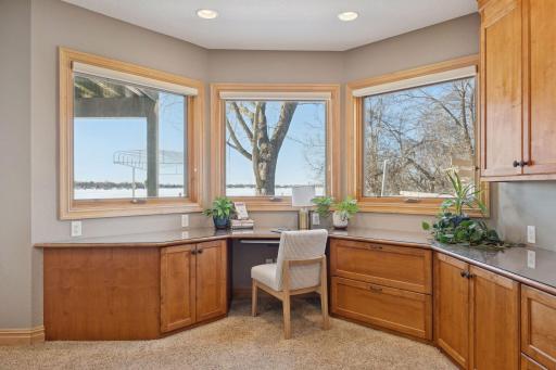 Bright lakeside workspace with wraparound windows and custom built-ins.