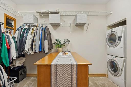 Spacious walk-in closet with built-in organization, washer and dryer, & convenient center island