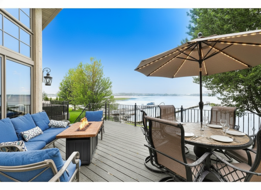 Beautiful lakeside deck with lounging and dining spaces, perfect for outdoor living and entertaining.