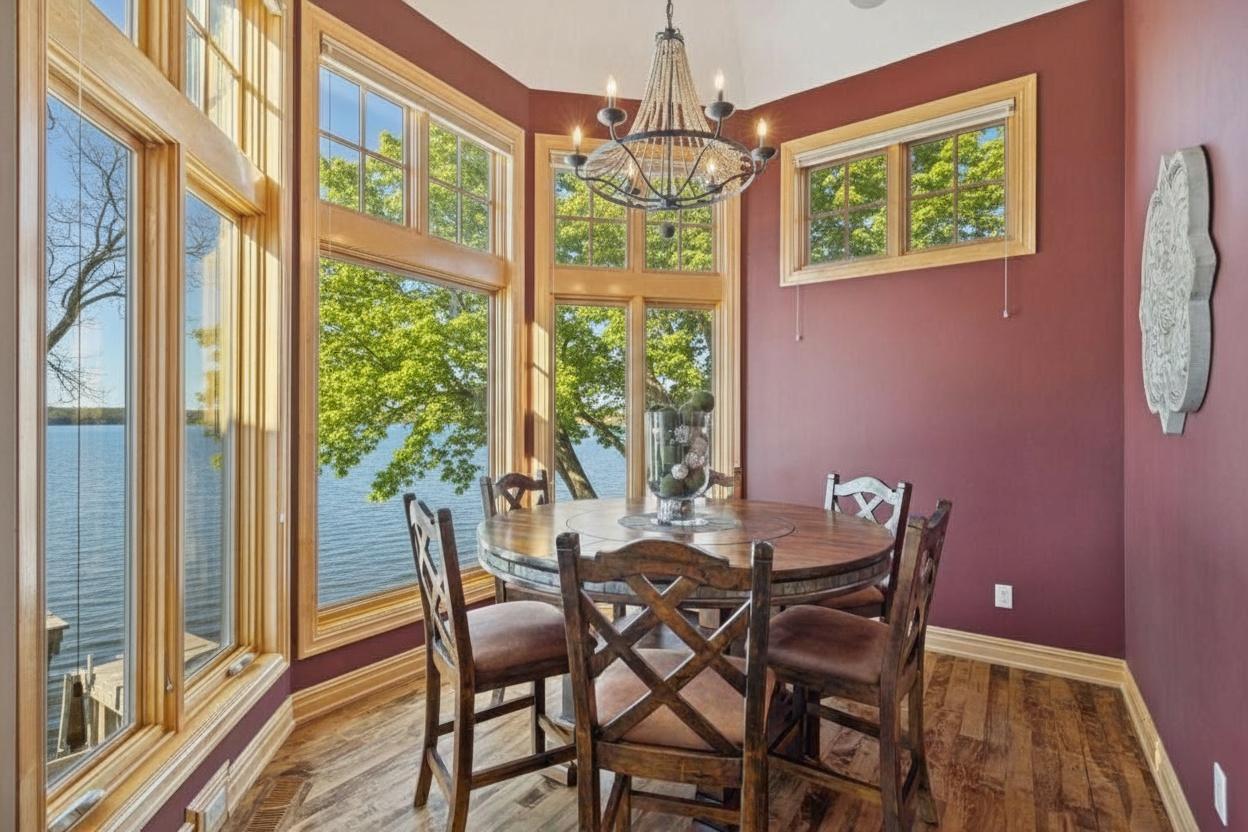 Sun-filled dining nook with panoramic windows and warm, inviting design—perfect for relaxed meals with a view.
