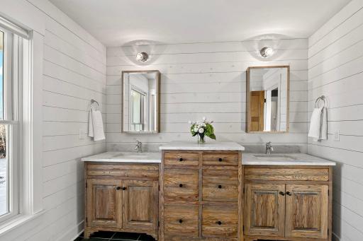 Custom cabinetry in the master bath with dual sinks.