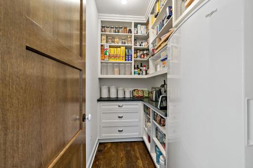 Walk in pantry with extra refrigerator and small appliance storage.