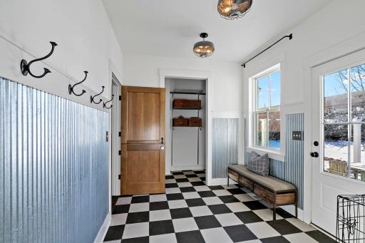 Walk in from garage to this spacious mudroom that walks out to the backyard area.