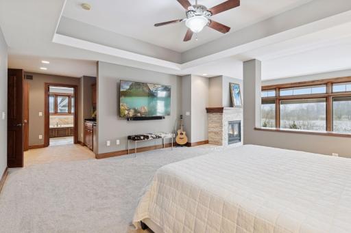 Primary bedroom features a sitting room with private balcony access and a full ensuite bathroom with walk-in closet
