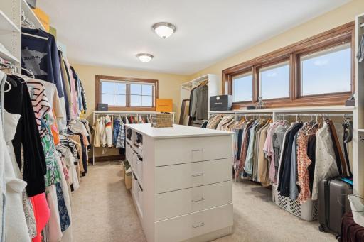 Primary walk-in closet with center island for extra organization