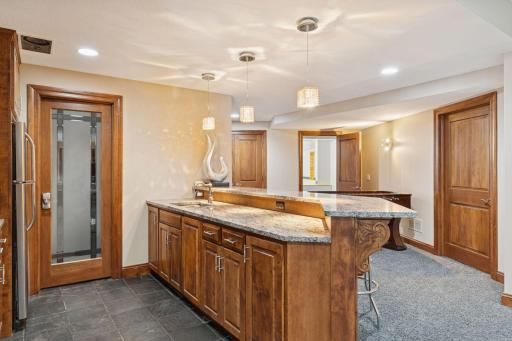 Features include a full fridge, wine/storage room, breakfast bar seating
