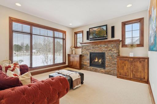 Step over to the family room on the other side of the kitchen featuring another cozy gas fireplace