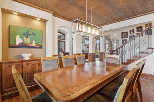 Elegant formal dining room featuring stunning lighting, expansive windows, and a refined setting perfect for hosting memorable gatherings