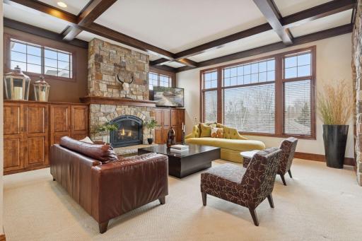 Step into the living room and unwind by the gas fireplace with a beautiful stone surround, while enjoying abundant natural light pouring in through oversized windows.