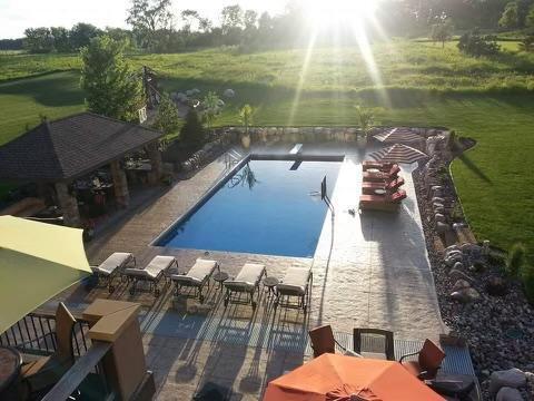 Enjoy outdoor entertaining poolside while taking in the tranquil views