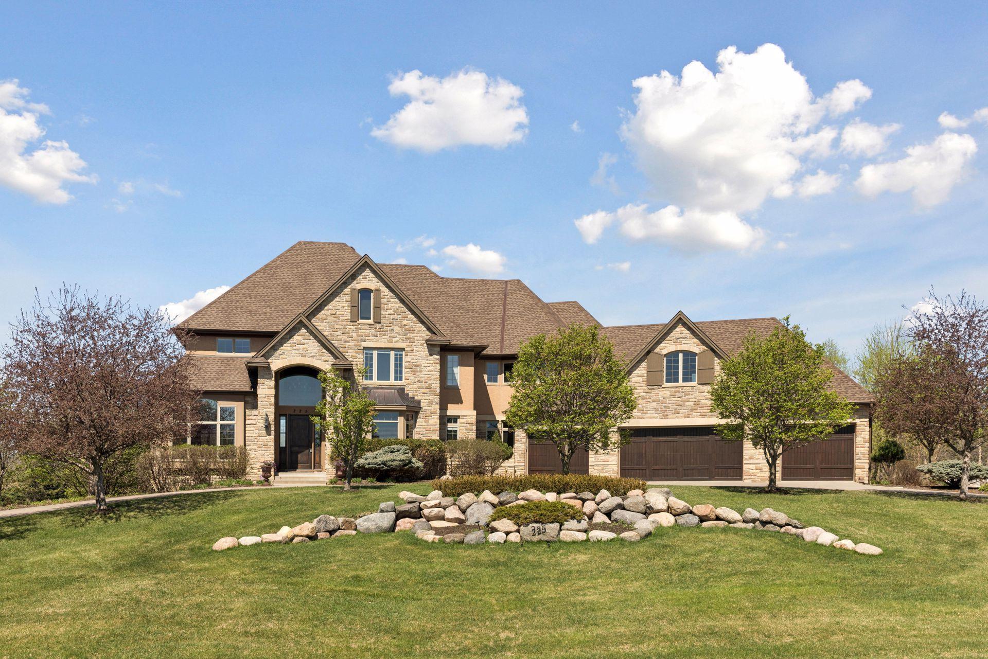 This home features stunning curb appeal, curved driveway, and 4-car garage
