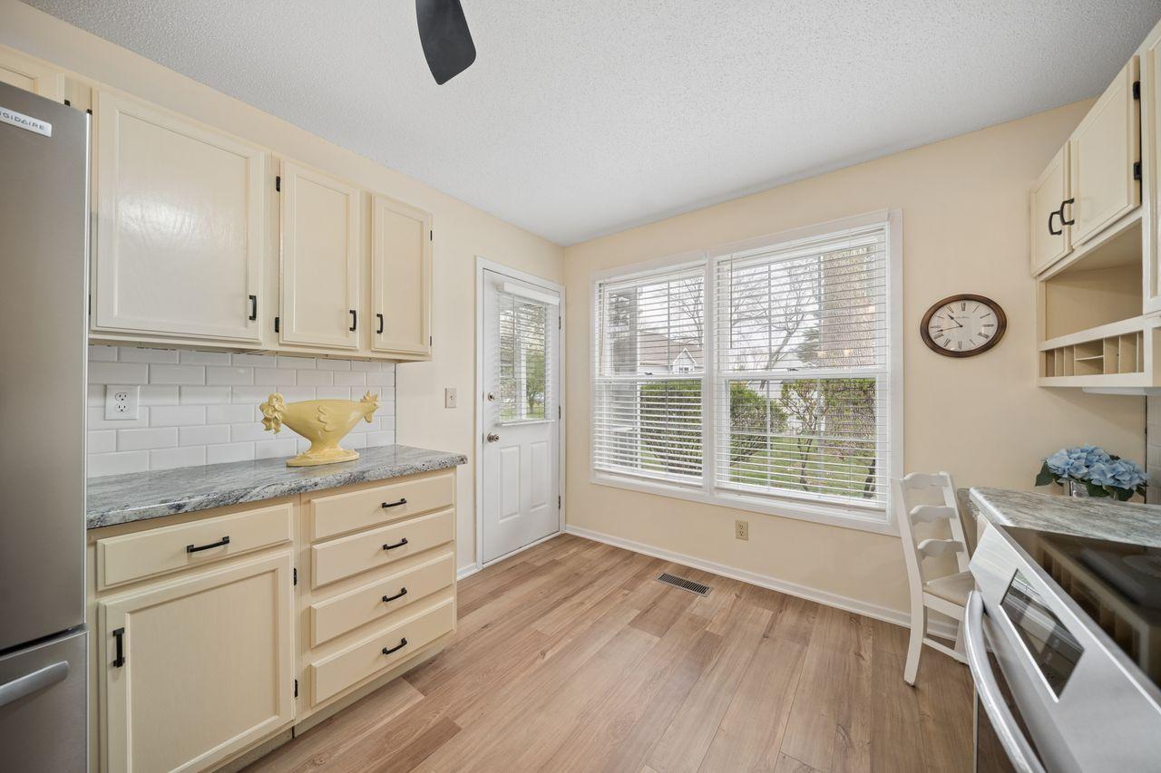 The large window overlooks the green courtyard to the back of the building. The door walks out to the screened porch.