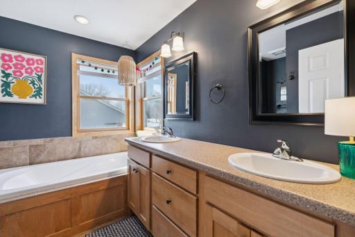 Private bath with tile shower and air-jet tub and separate shower.